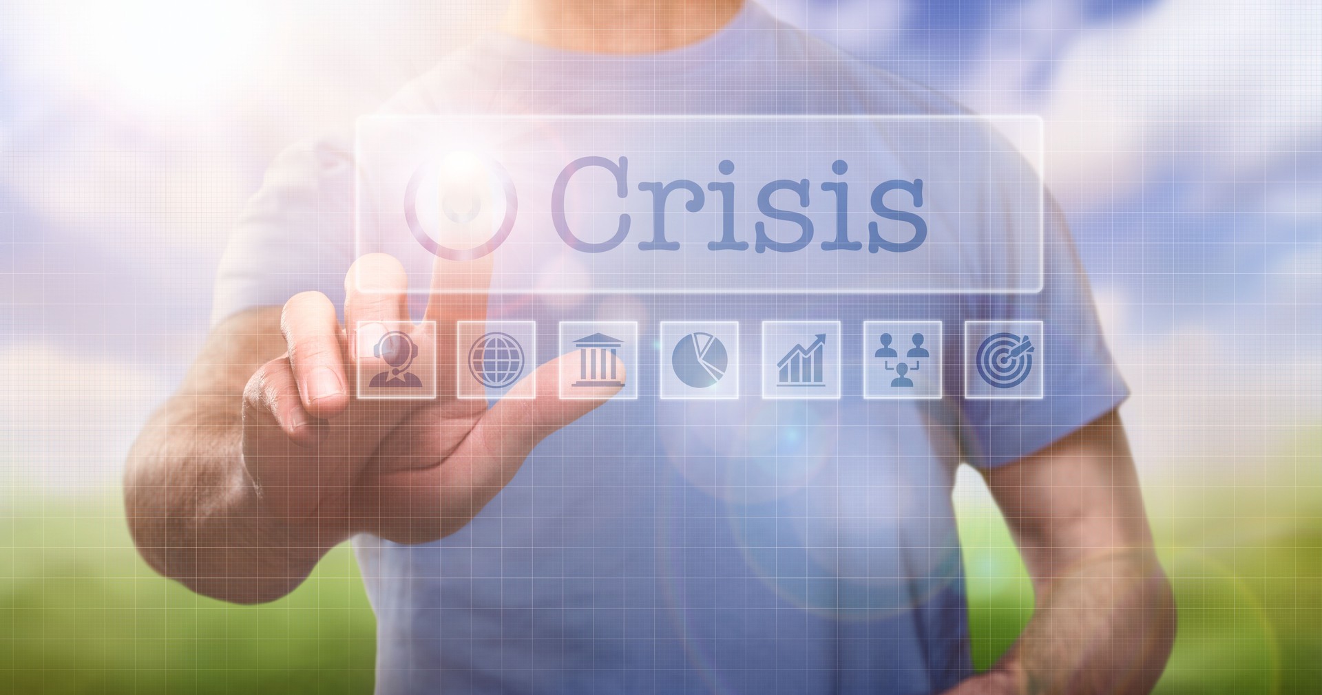 A man in a t-shirt outside selecting the word Crisis on a computerised display